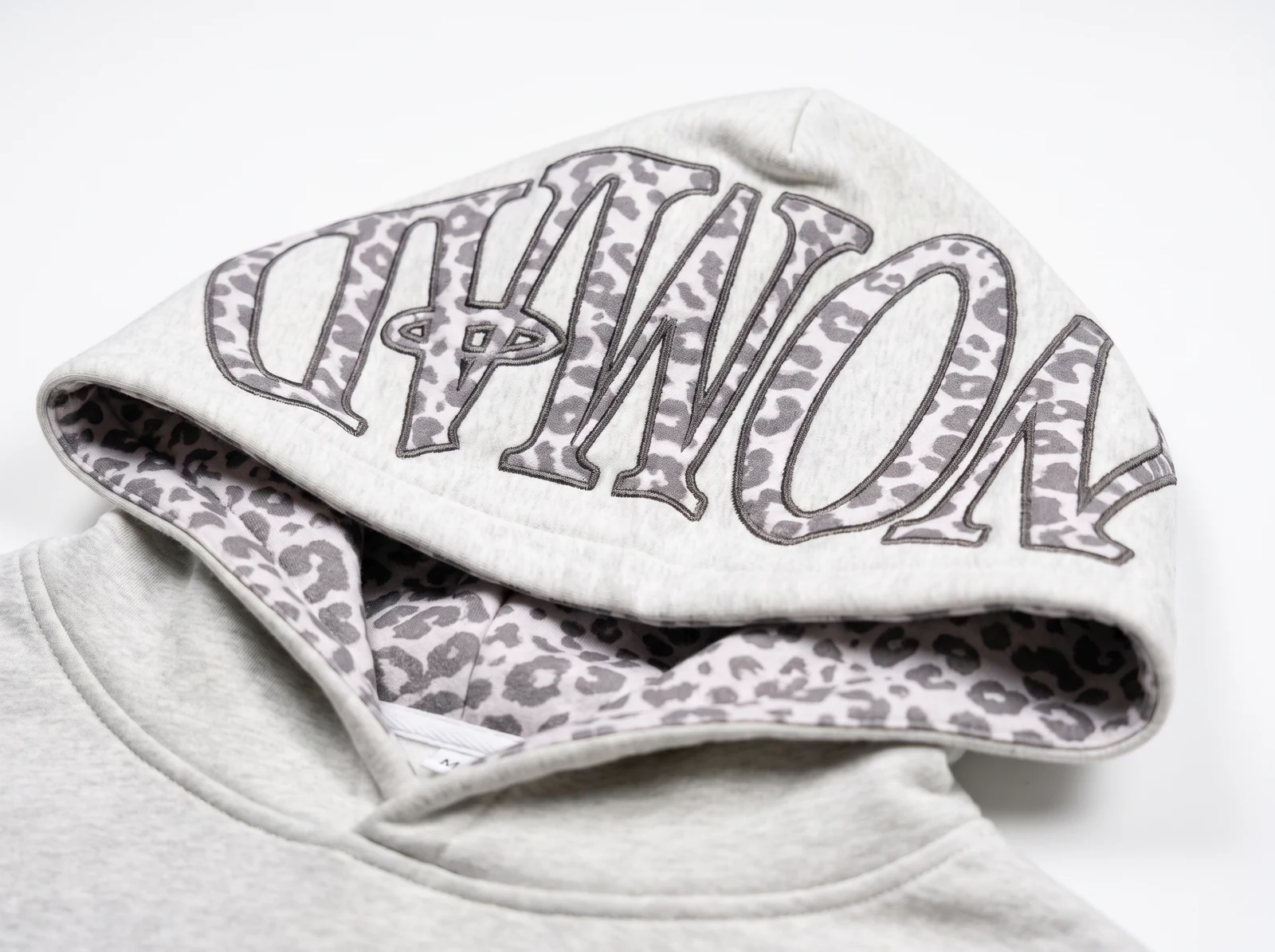 NOMAD arched across the hood in snow leopard appliqué