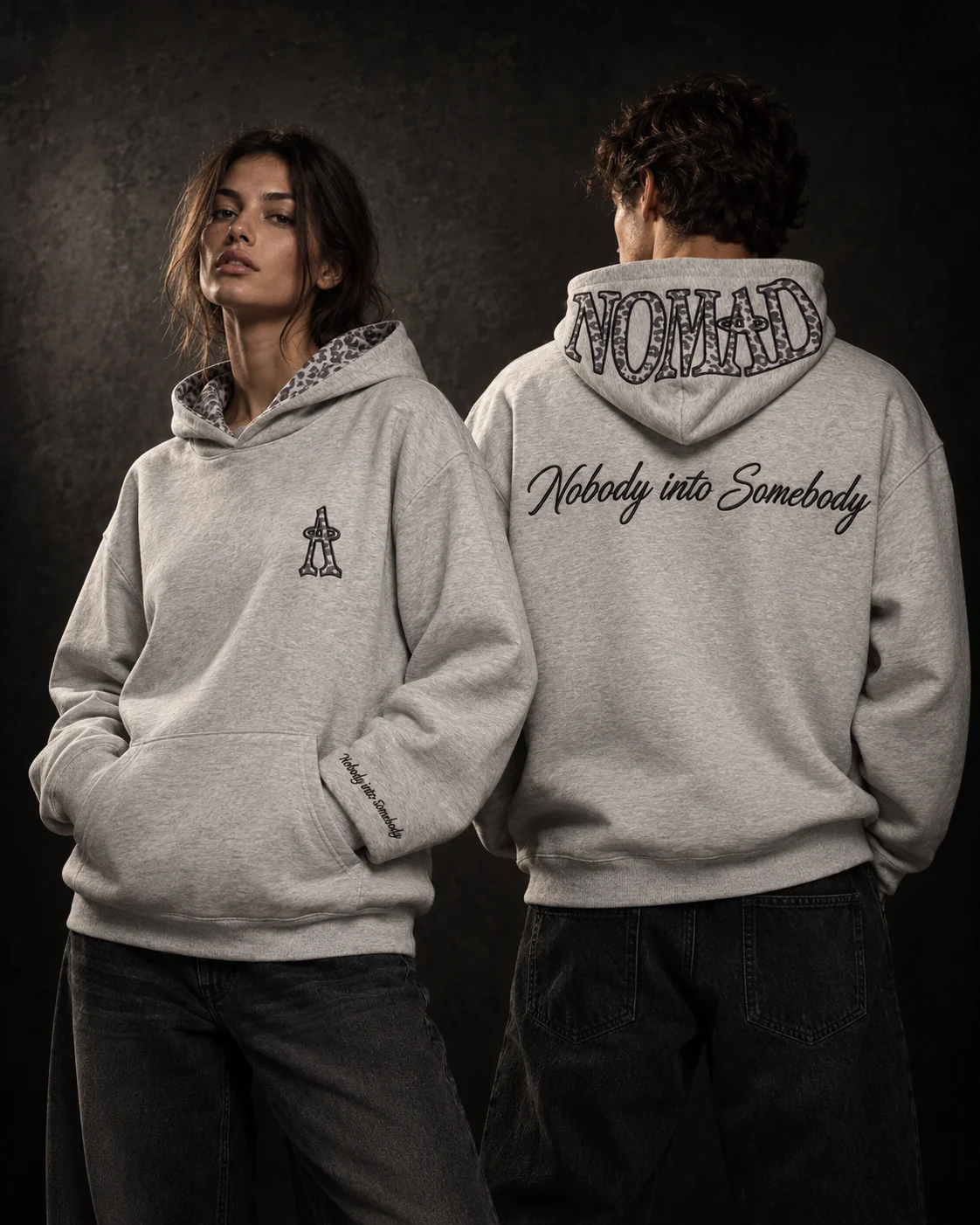 Two people wearing the Ash Heather Hoodie, front and back, studio.