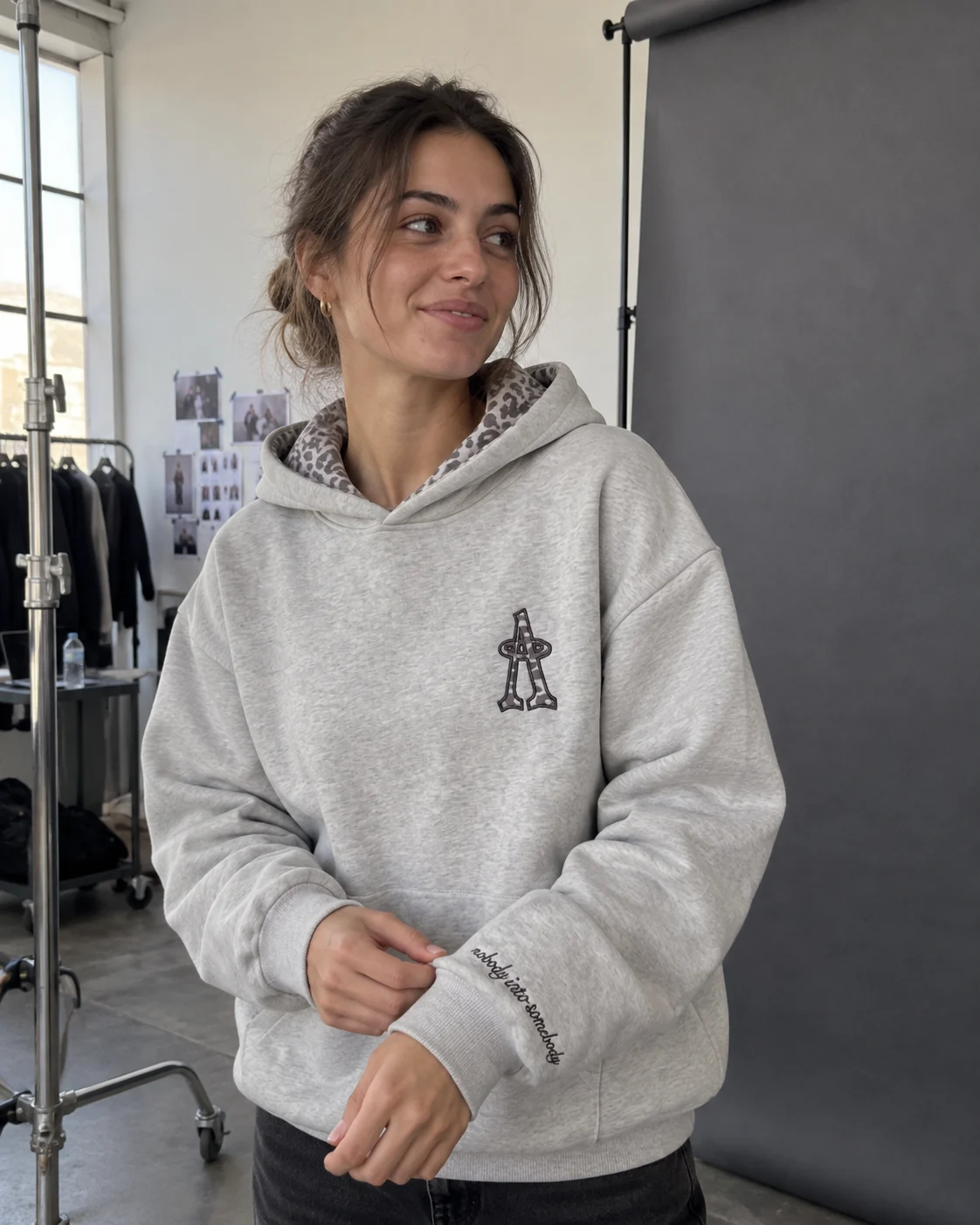 The hoodie worn in a studio by a window.